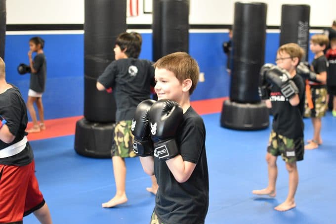 Smiling boy in a kids martial arts class at Next Level Martial Arts