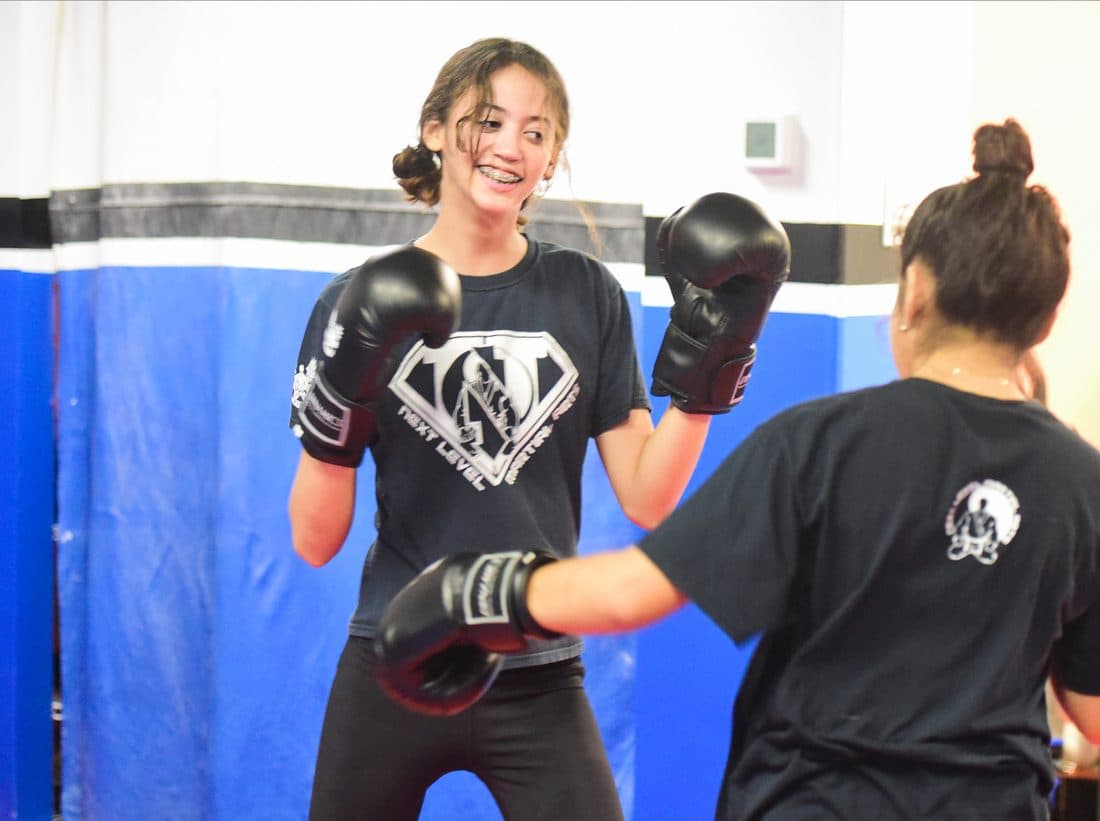 Teen girl training Muay Thai in the Pre-Teen and Teen class at Next Level