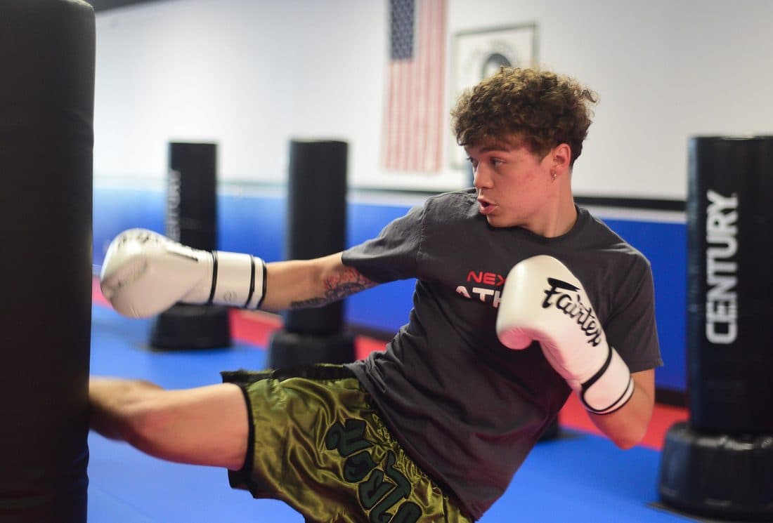 Teen landing a kick during an advanced Muay Thai class at Next Level