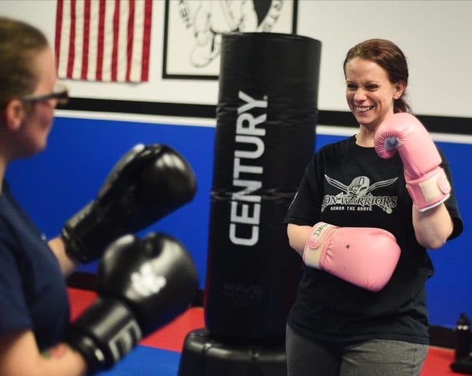 Adult member smiling during a kickboxing class at Next Level Martial Arts